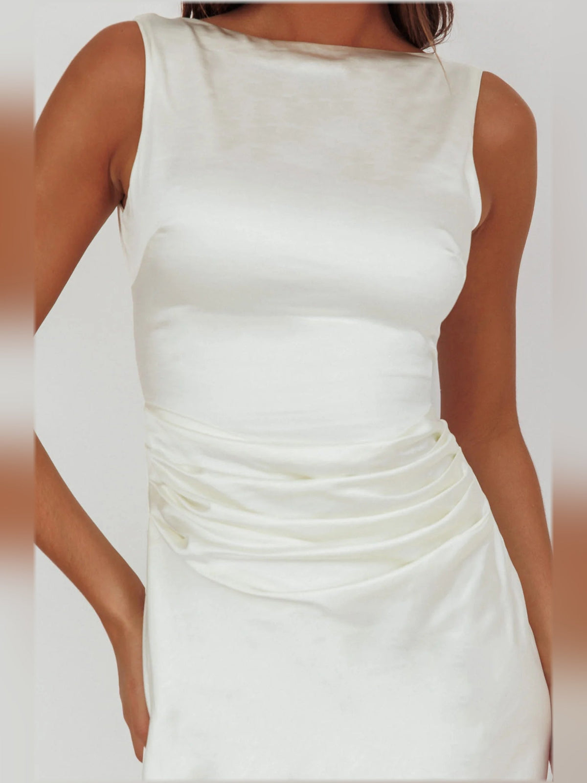 White sleeveless midi formal dress close-up, ruched drape and fitted bodice