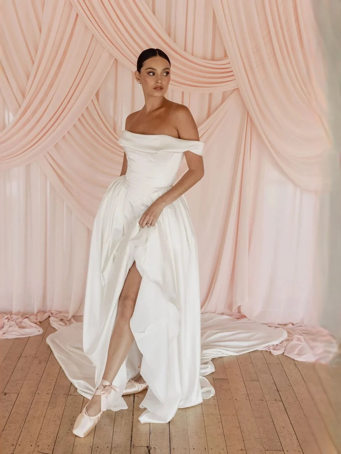 Ivory off-shoulder satin ball-gown wedding dress with front slit and draped waist