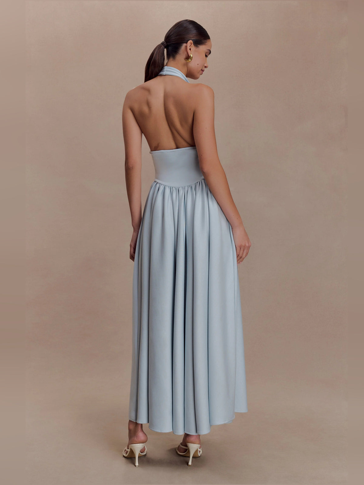 Light blue open-back halter midi dress with gathered waist and pleated skirt