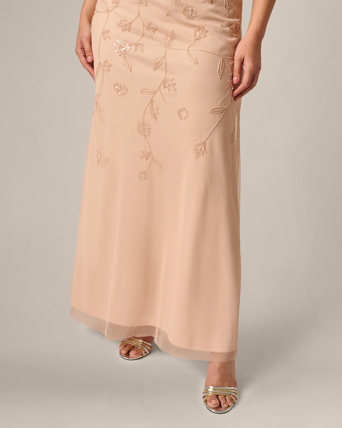 Blush pink A-line maxi skirt with subtle floral sequin pattern and sheer hem