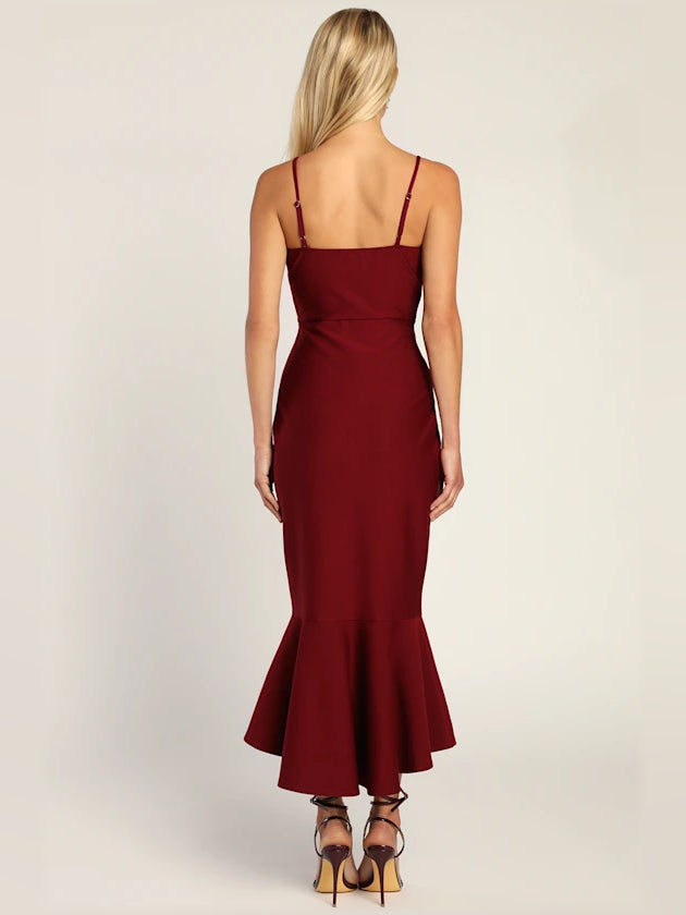 Wine red bodycon midi dress back view with spaghetti straps and trumpet hem flare.