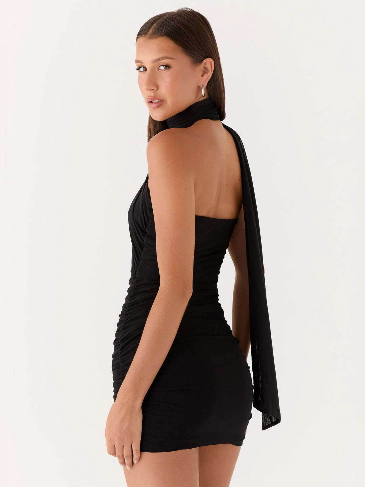 Black ruched mini halter dress with open back and long draped neck scarf