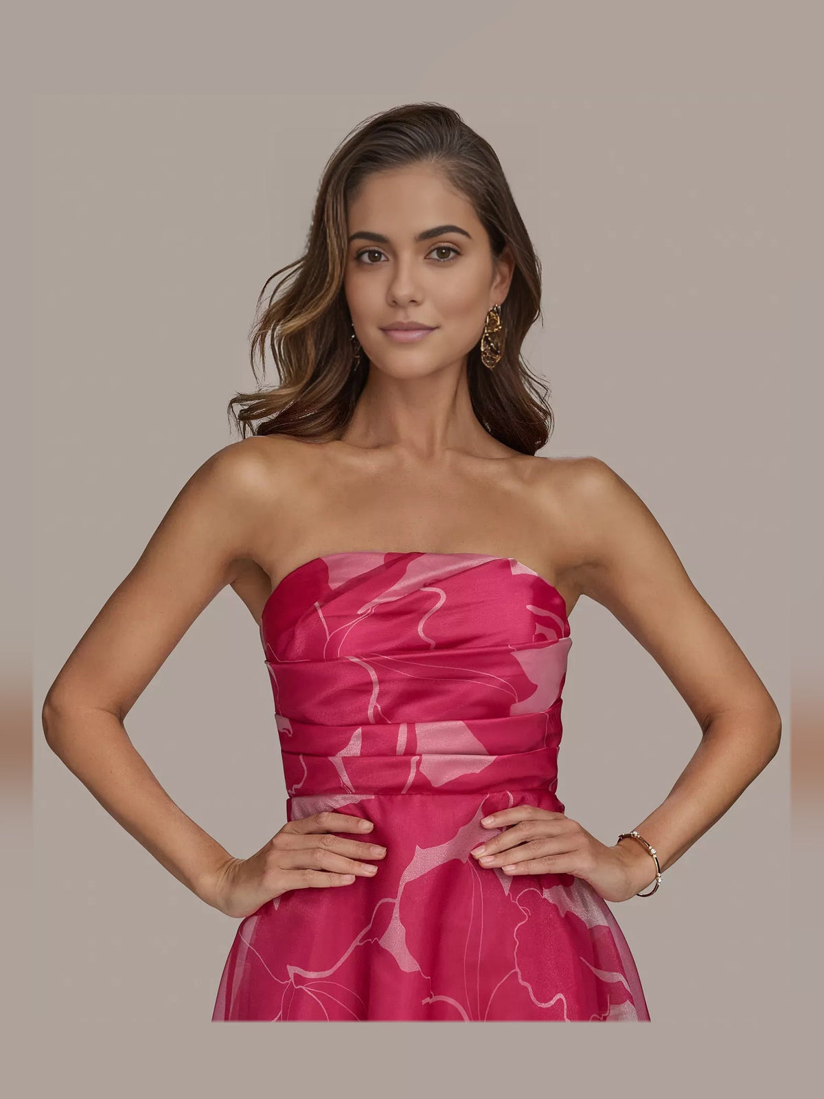 Close-up of fuchsia strapless ruched dress with abstract white print and fitted waist
