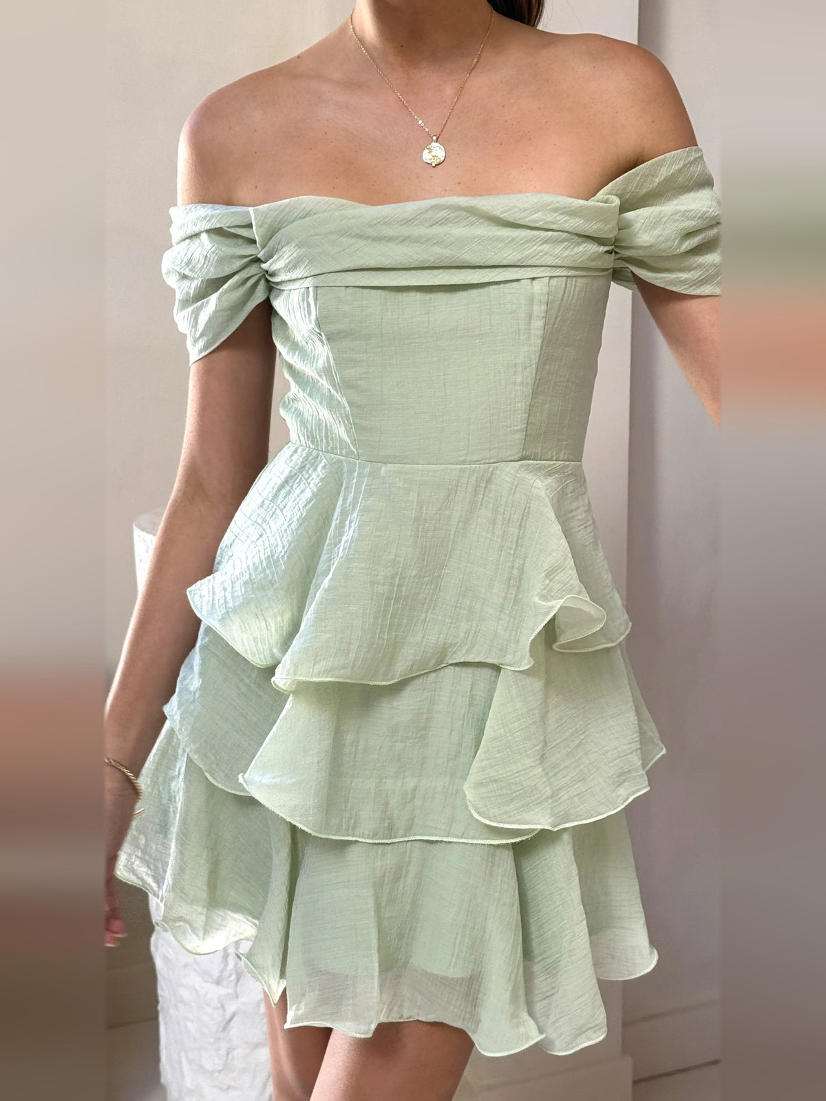 Sage off-shoulder mini dress bodice with ruched detail and tiered ruffles