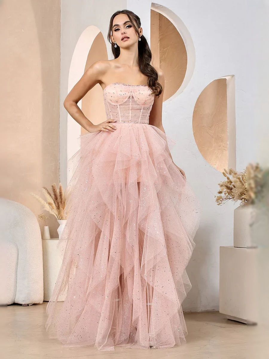 Blush pink strapless corset prom dress with ruched bodice and full A-line tulle skirt