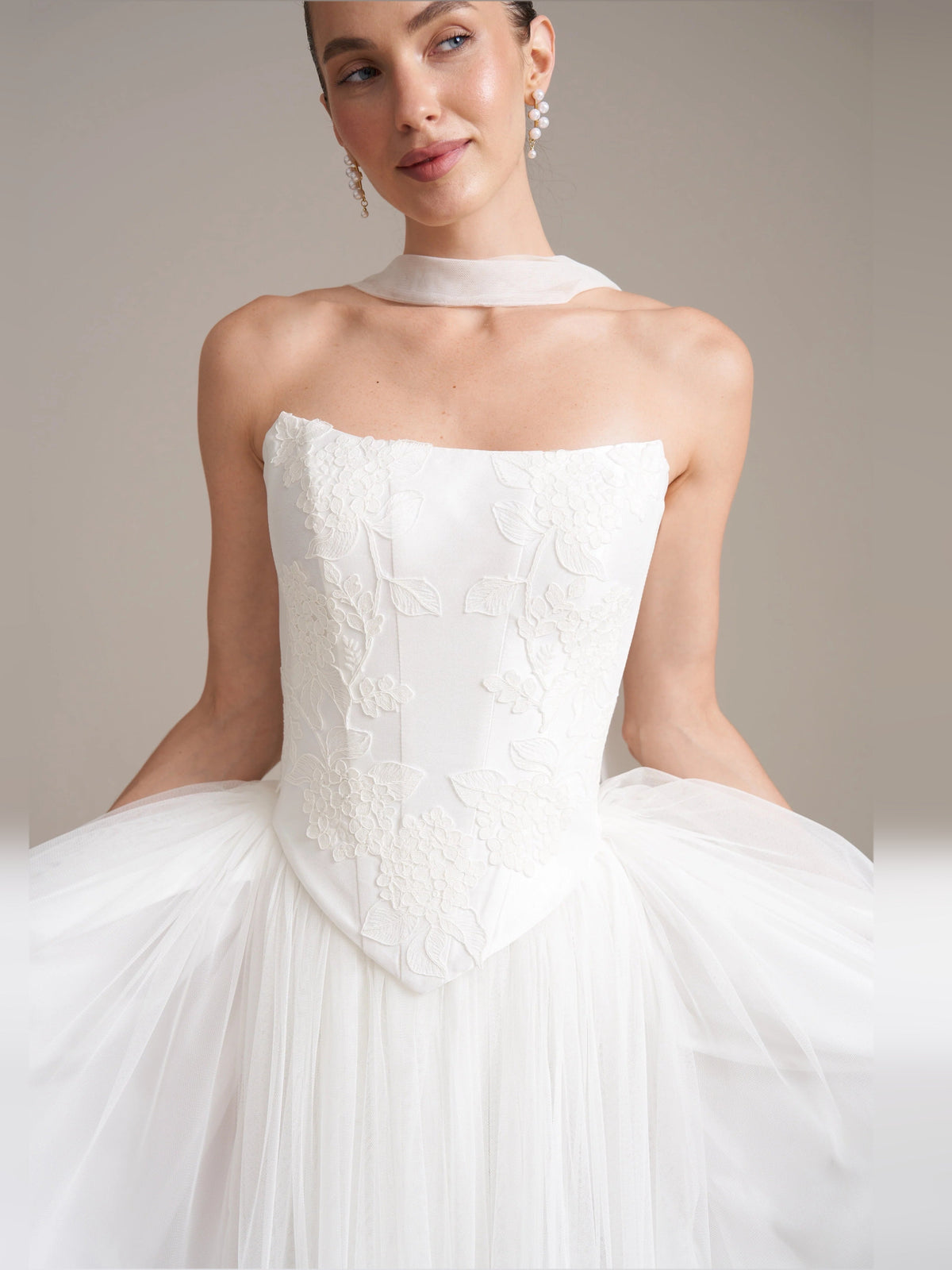 Ivory strapless corset wedding dress with floral lace bodice and full tulle skirt