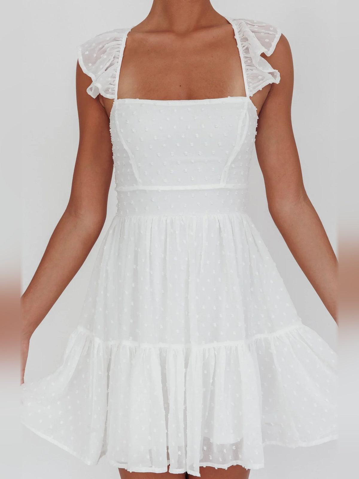 White square-neck mini dress with flutter sleeves and tiered ruffle skirt
