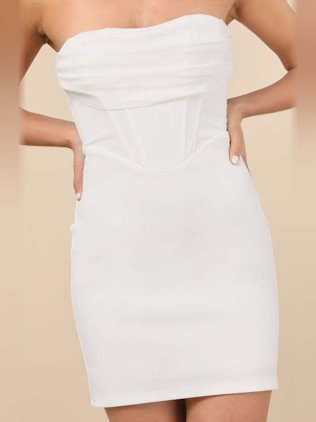 White strapless mini dress close-up with corset seams and fitted waist panel