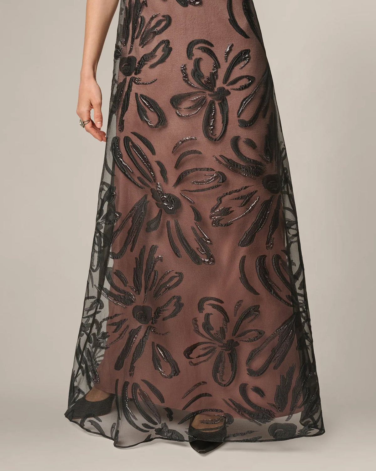 Black A-line maxi dress with short sleeves, ornate floral pattern and flowing hem