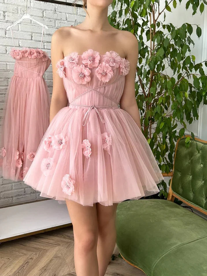 Light pink strapless tulle mini dress with layered skirt and large floral appliques on bodice