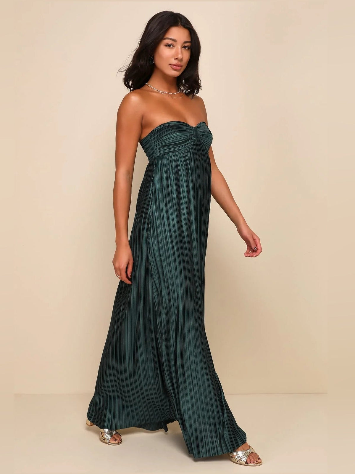 Emerald green strapless satin maxi dress with ruched bodice and flowing pleated skirt