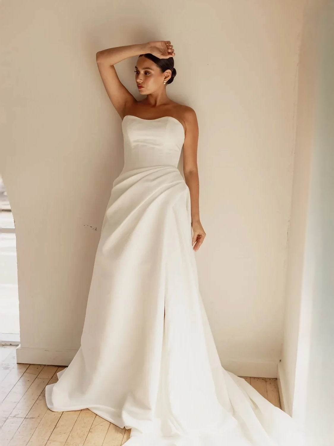 Ivory satin strapless corset ballgown with sculpted bodice and sweeping floor skirt