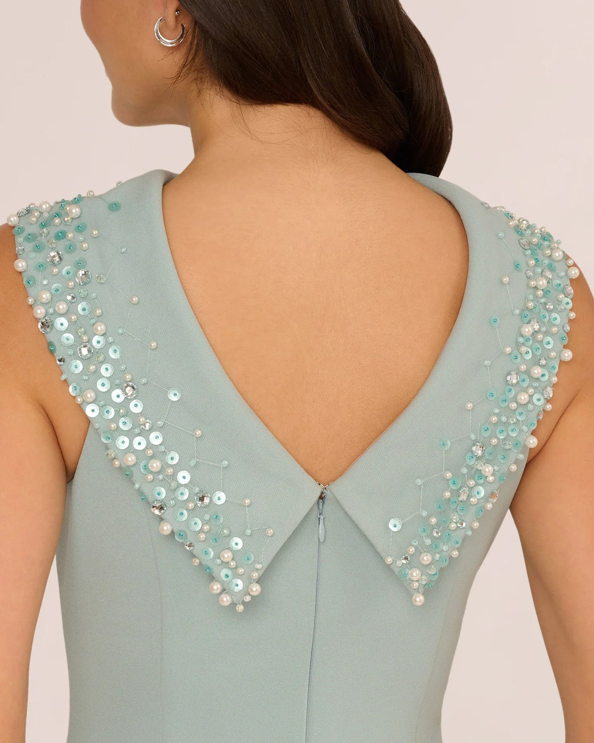 Back view of pale aqua sheath maxi dress with V-back and beaded shoulder detailing.