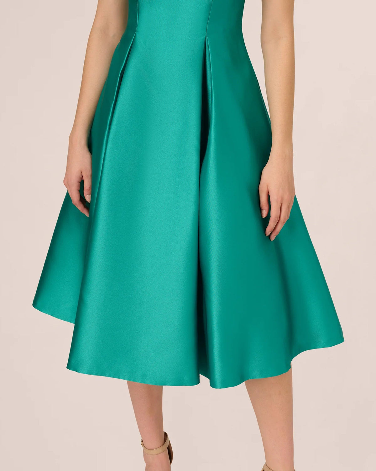 Emerald green fit-and-flare midi skirt with structured pleats and flared hem