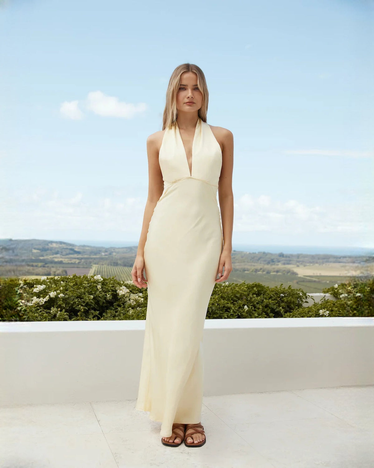 Ivory satin sleeveless maxi dress with halter neckline and draped A-line skirt
