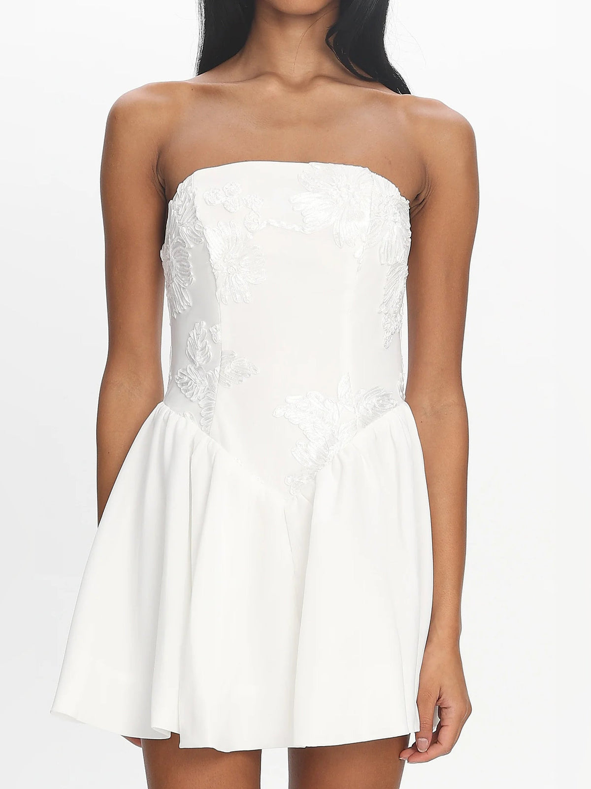 White strapless mini dress with textured bodice and ruched seam at bust