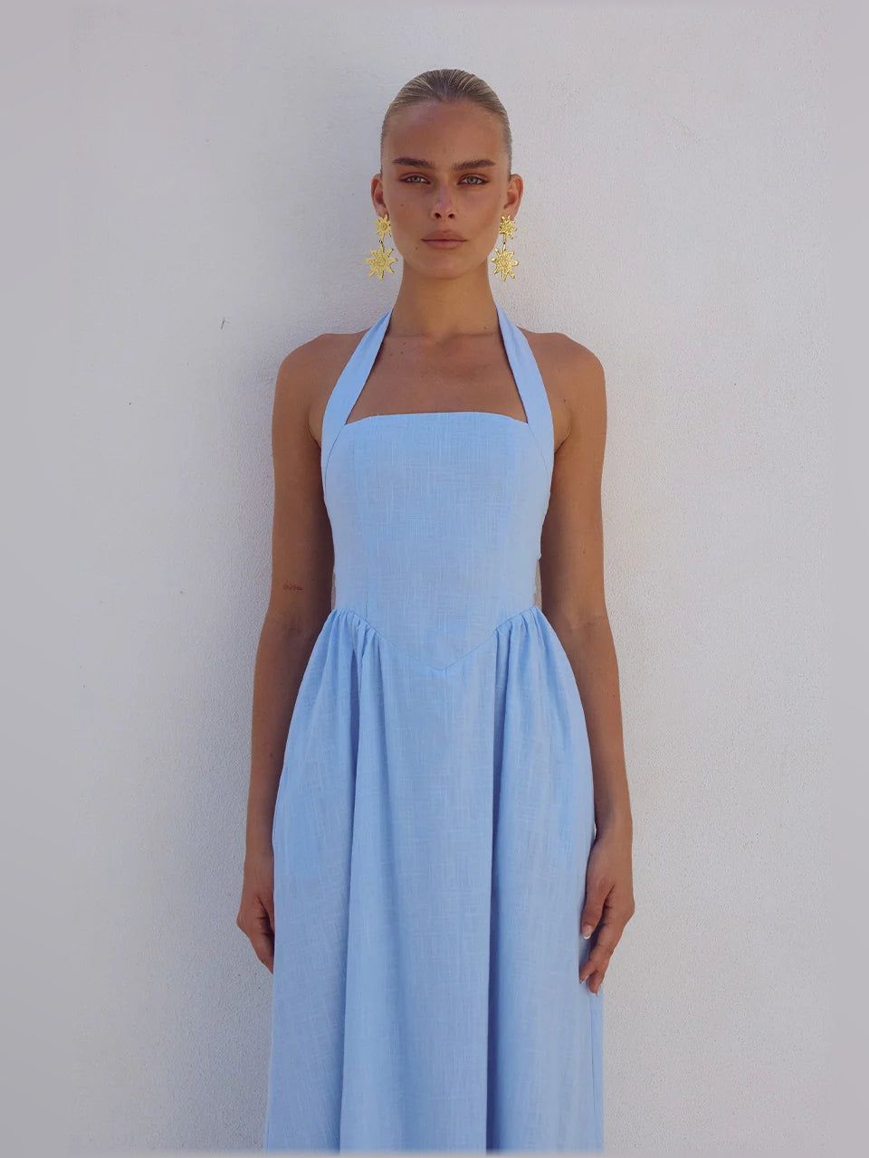 Ice blue midi formal dress close-up of square neckline, halter straps, and bodice