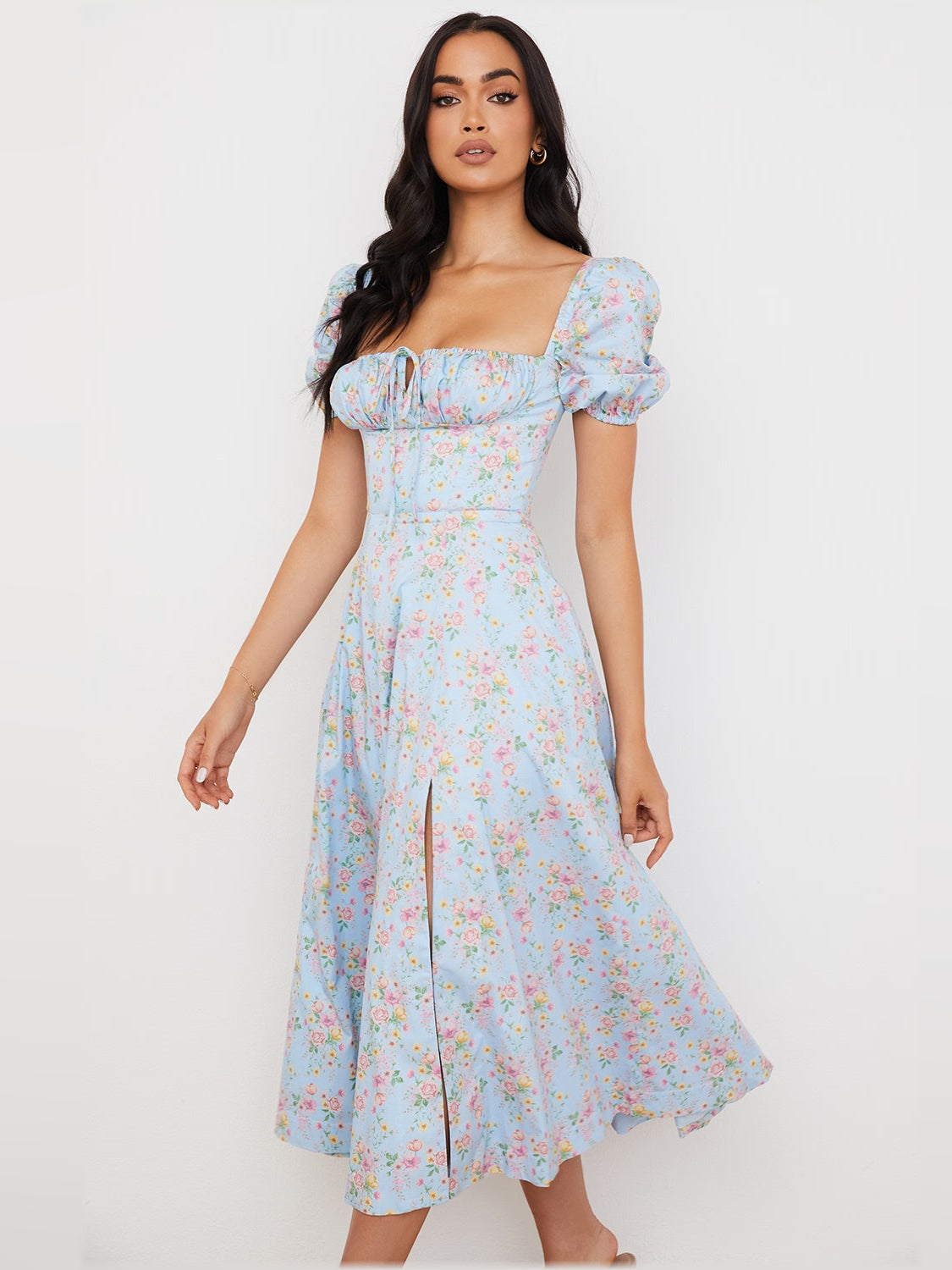 Floral midi dress featuring puff sleeves, ruched bodice, and midi A-line skirt