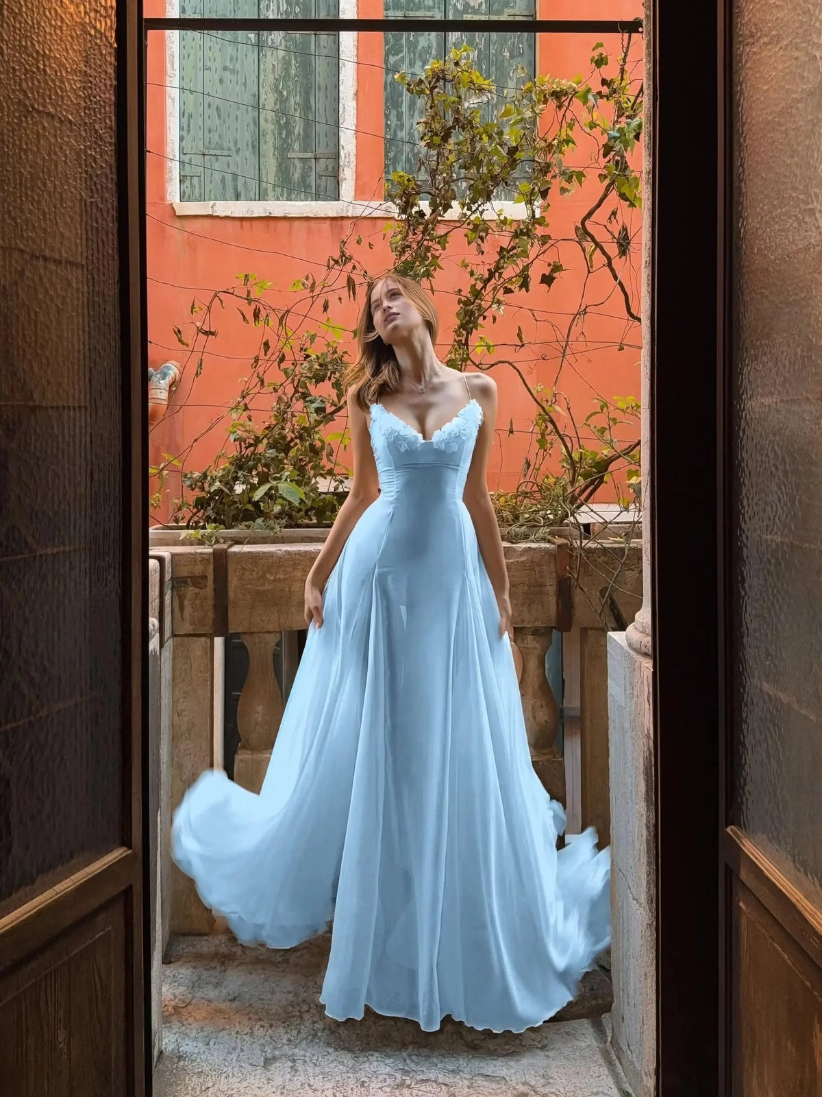 Light blue sleeveless sweetheart A-line prom dress with draped floor-length skirt