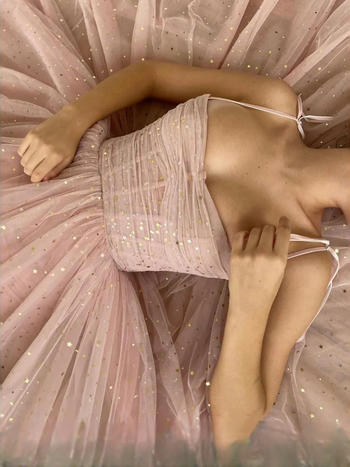 Dusty pink tulle bodice detail with sparkly ruched fabric and tied back spaghetti straps