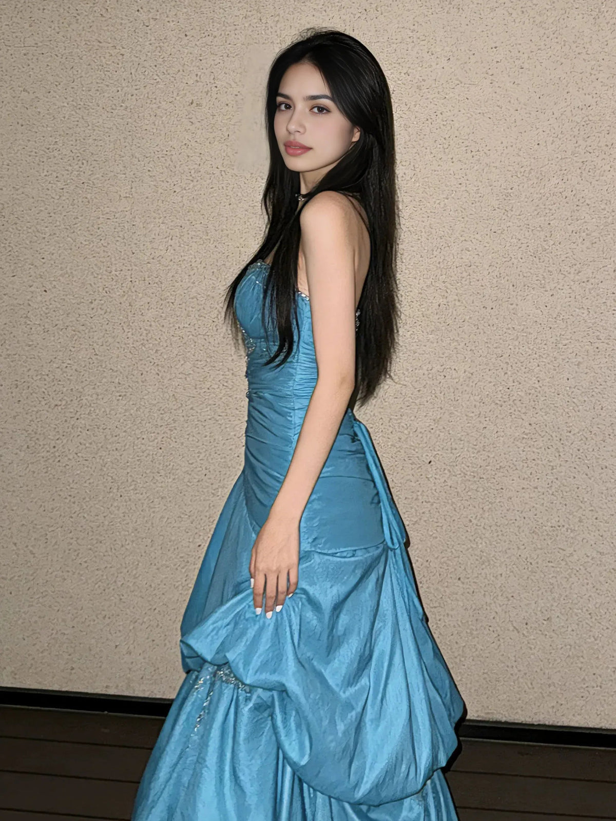 Teal satin A-line maxi prom dress with ruched bodice and ruffled tiered skirt, side view