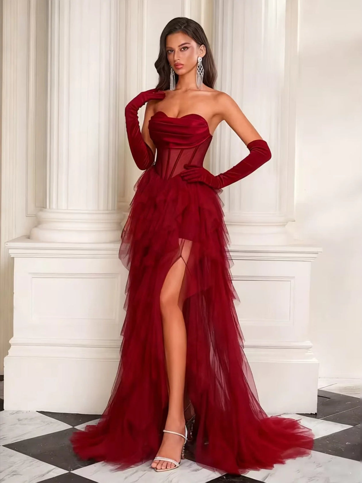 Burgundy strapless corset prom dress with tiered tulle skirt, front slit, long gloves