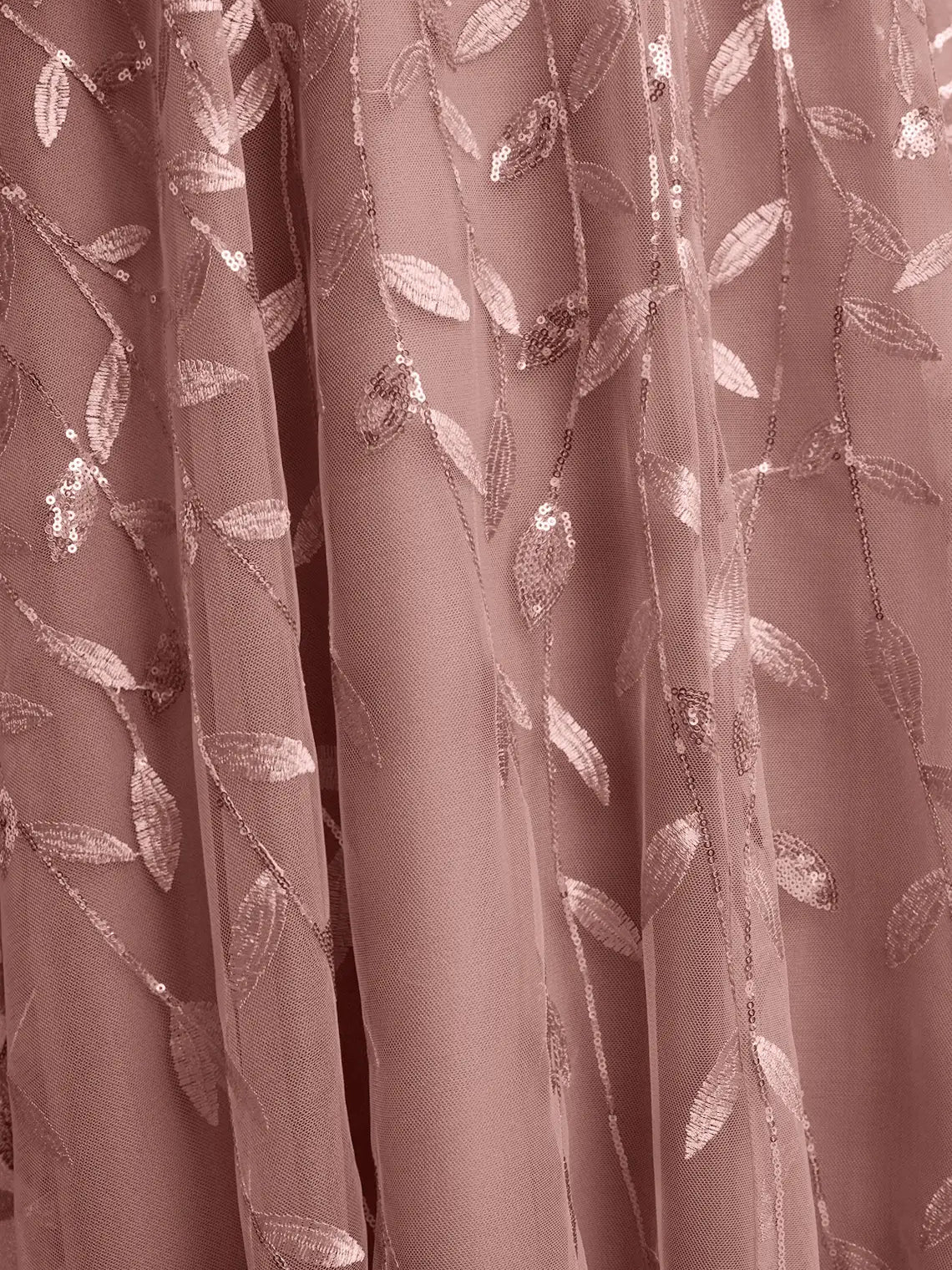 Dusty rose tulle fabric with embroidered leaf pattern, close-up