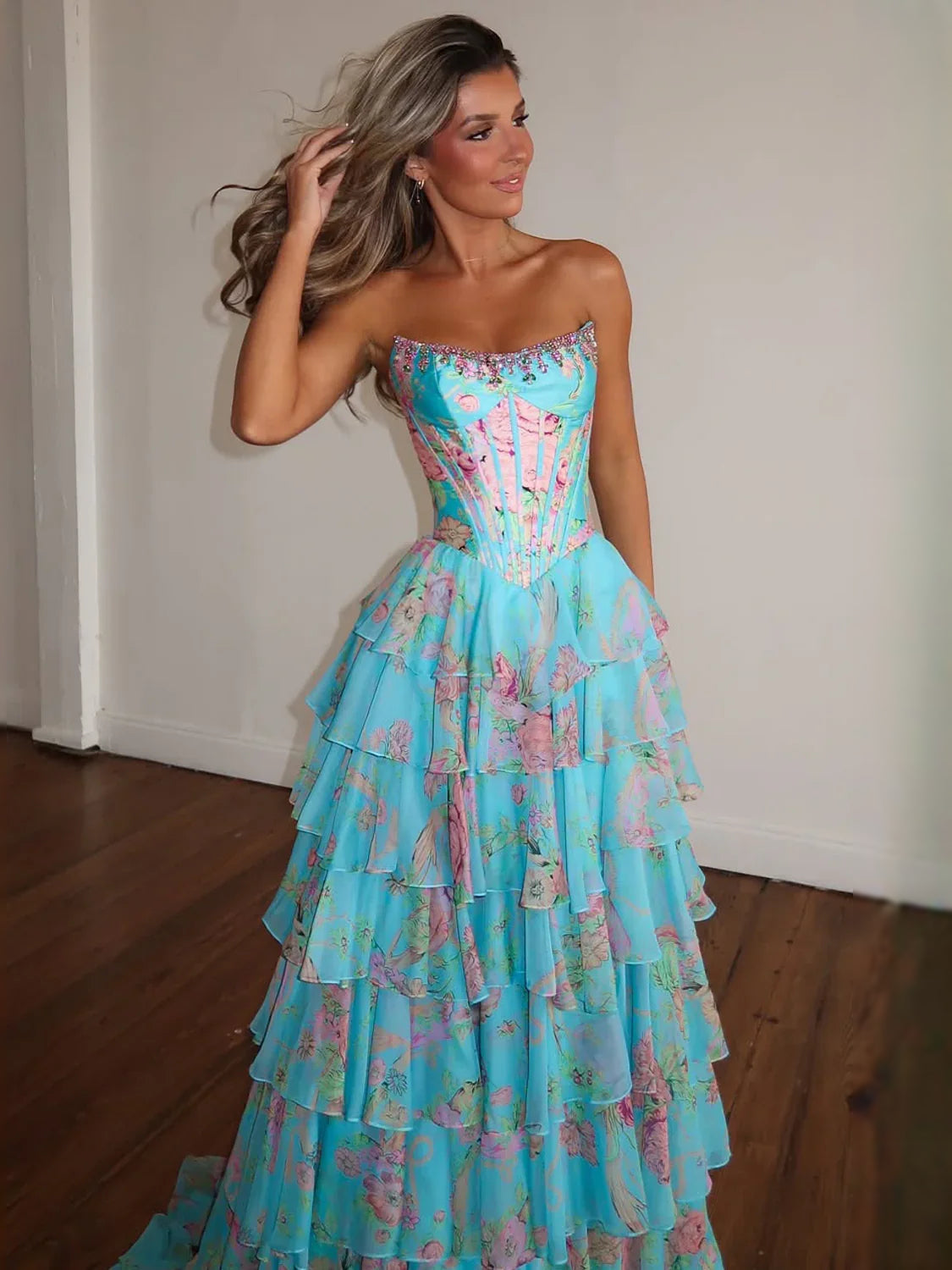 Aqua strapless corset floral tiered gown with flowing ruffle skirt