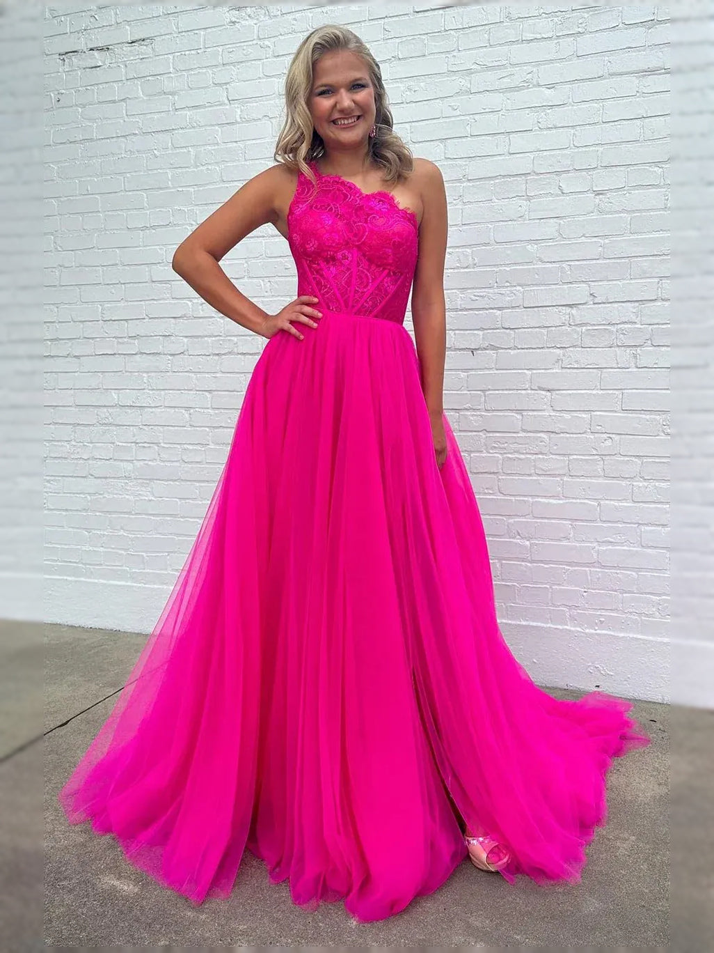 Hot pink sweetheart corset ball gown with layered tulle skirt and off-shoulder lace bodice