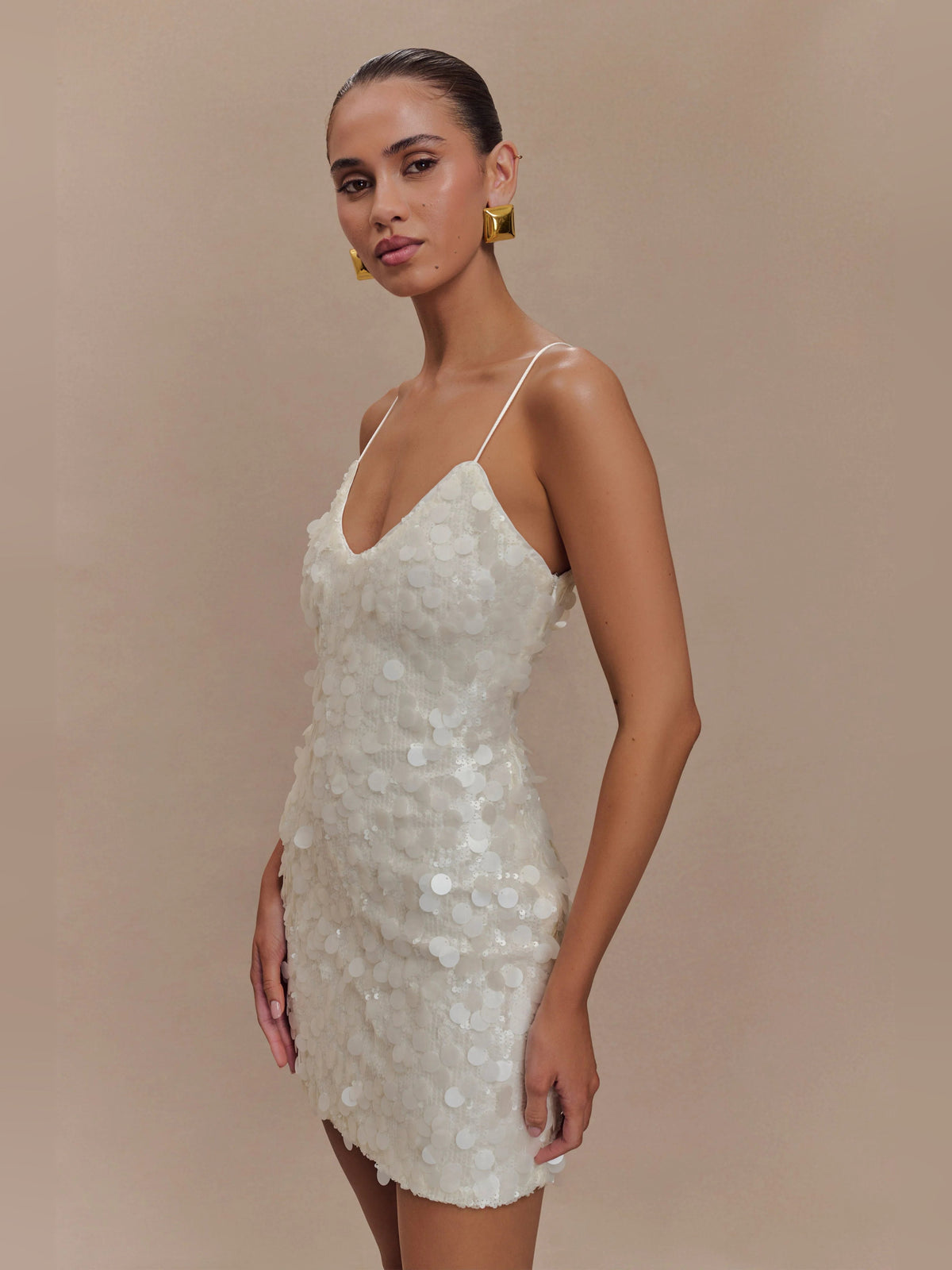 Ivory sequin mini dress with V-neck, spaghetti straps, and scalloped edges