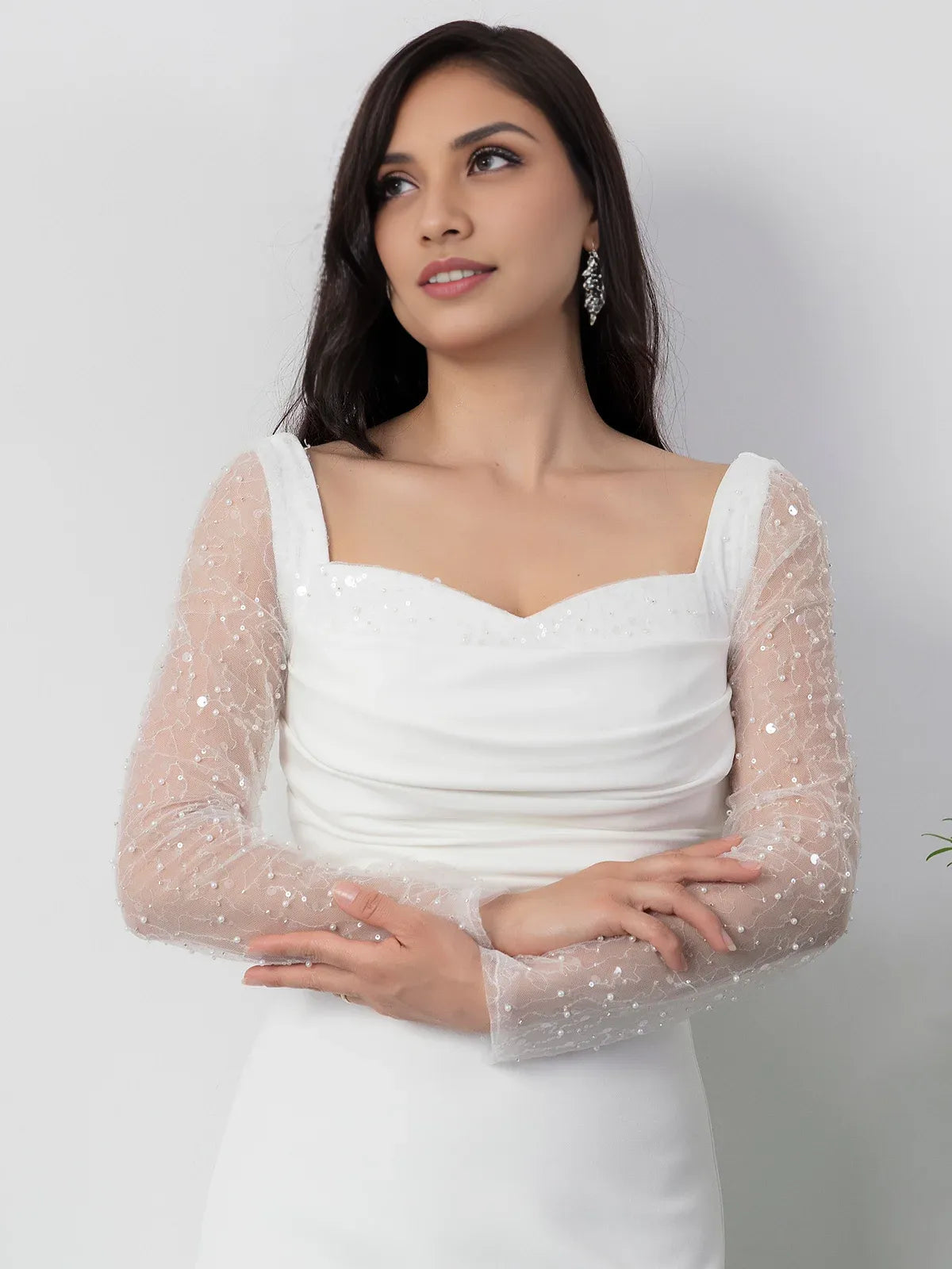 White square-neck formal dress with sheer long sleeves and ruching, floor-length
