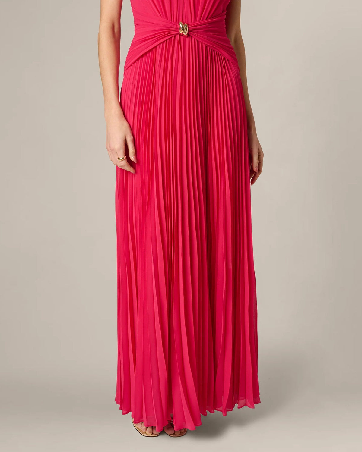 Cherry red pleated A-line maxi dress with halter neckline and gold belt detail