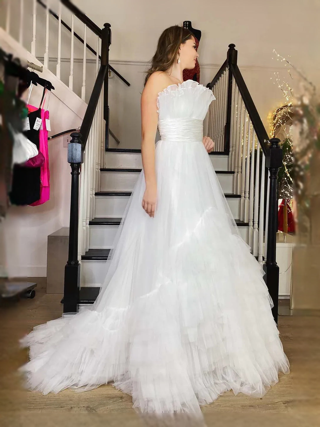 White sweetheart strapless maxi dress with ruched bodice and layered ruffle tulle skirt.
