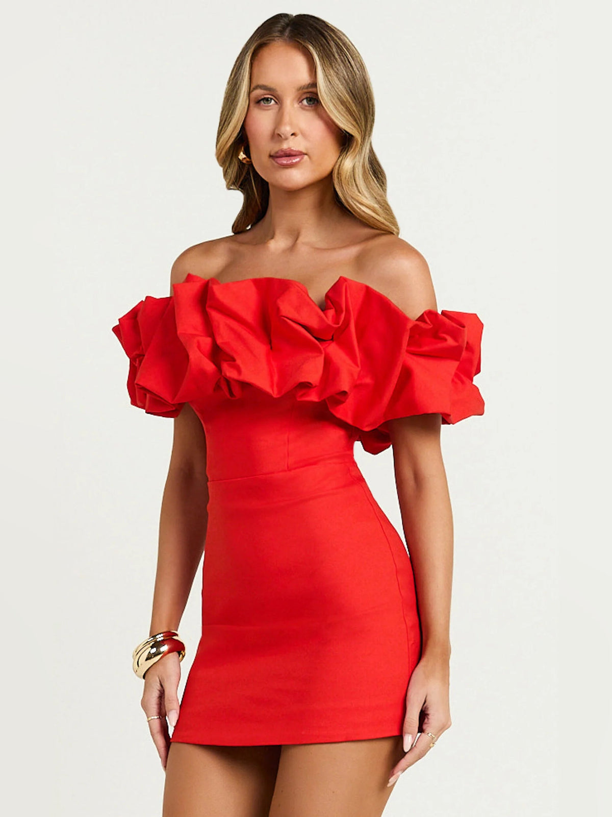 Red off-shoulder mini dress featuring large layered ruffles, fitted silhouette