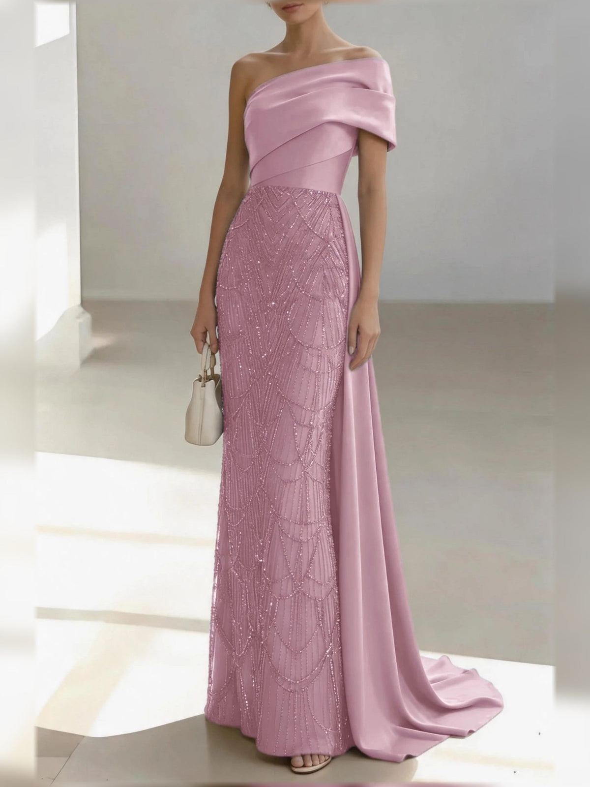 Pink one-shoulder satin mermaid gown with draped bow and beaded lace panel