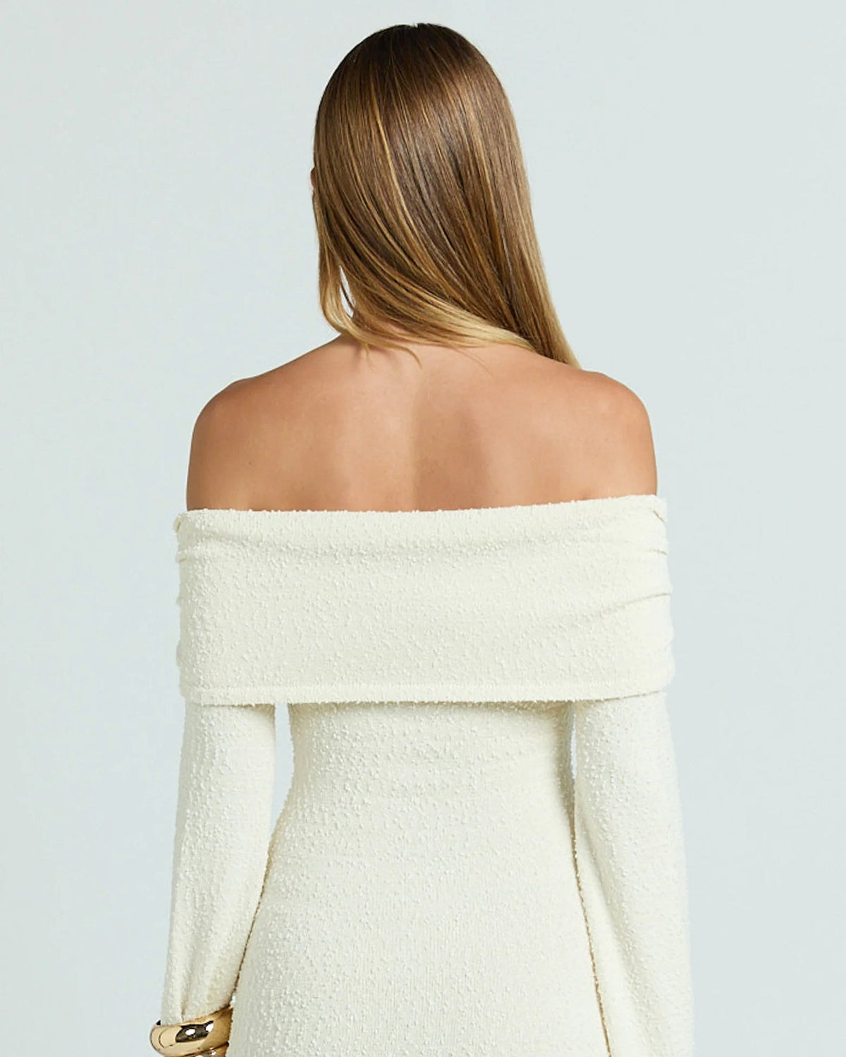 Cream knitted off-shoulder mini dress, open back and long sleeves, tie-waist detail
