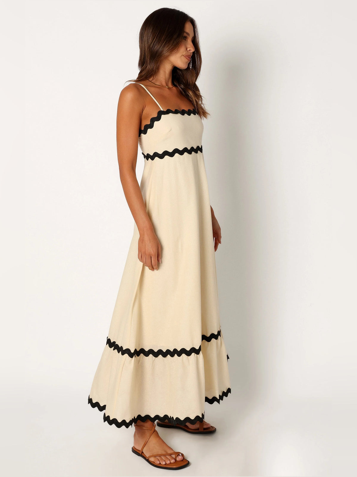 Black a-line maxi formal dress with strapless neckline, alternate full-length view showing the skirt