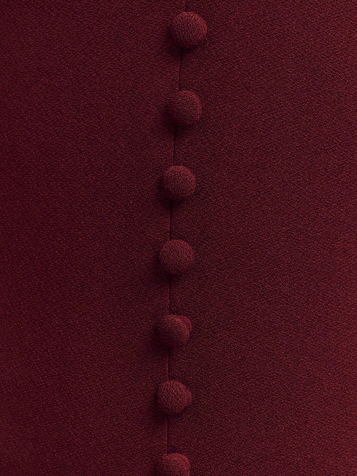 Merlot crepe button-front trim on the halter neckline