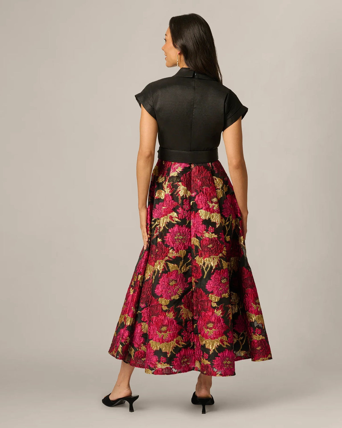 Back view of black belted V-neck maxi dress with floral A-line skirt