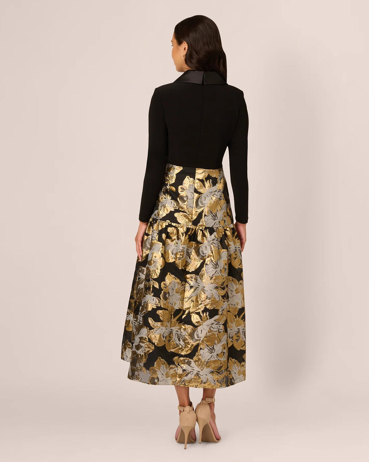 Back view of A-line maxi dress with black long-sleeve bodice and gold floral skirt