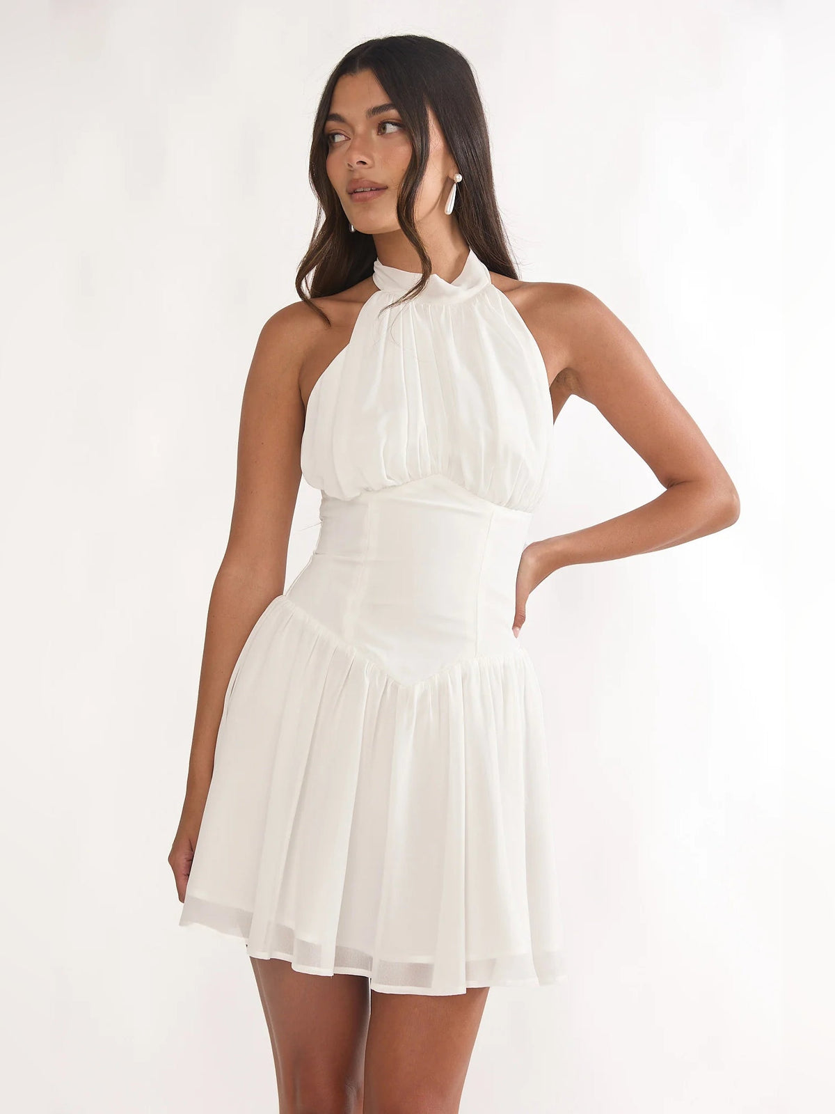 White halter mini dress with high neck, ruched bodice, and tiered skirt layers