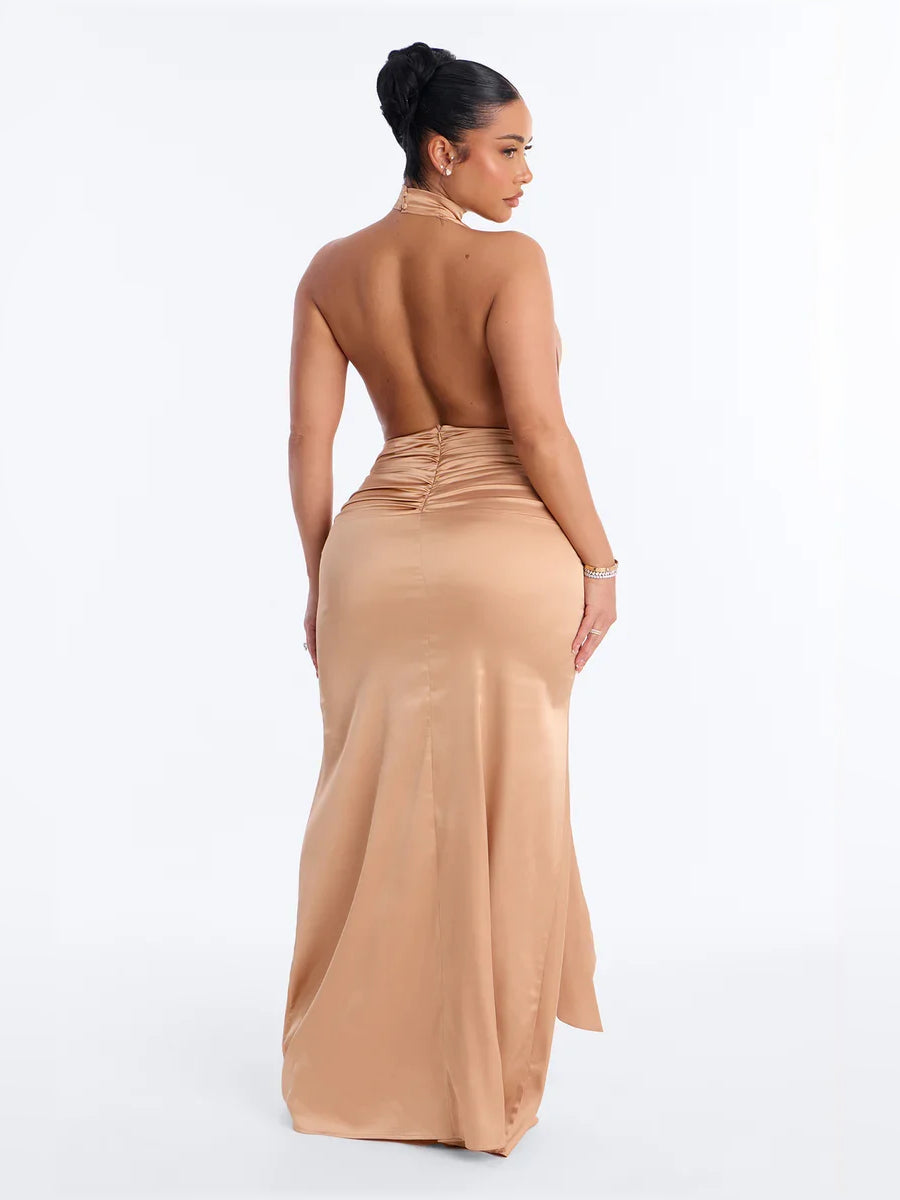 Champagne halter neck corset-style formal dress with open back and long draped skirt