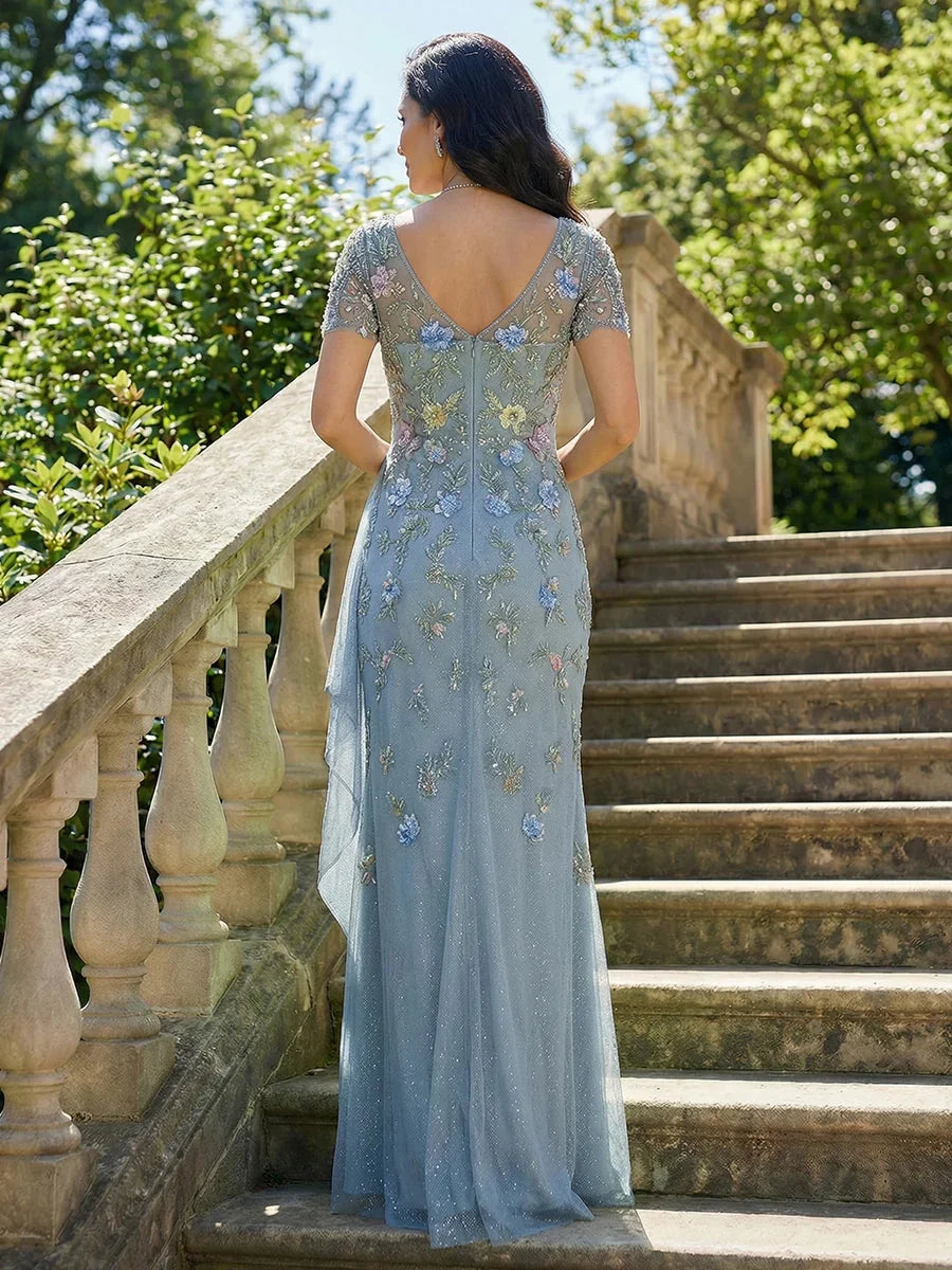 Steel blue chiffon mermaid dress viewed from the back with V-neckline and floral appliques