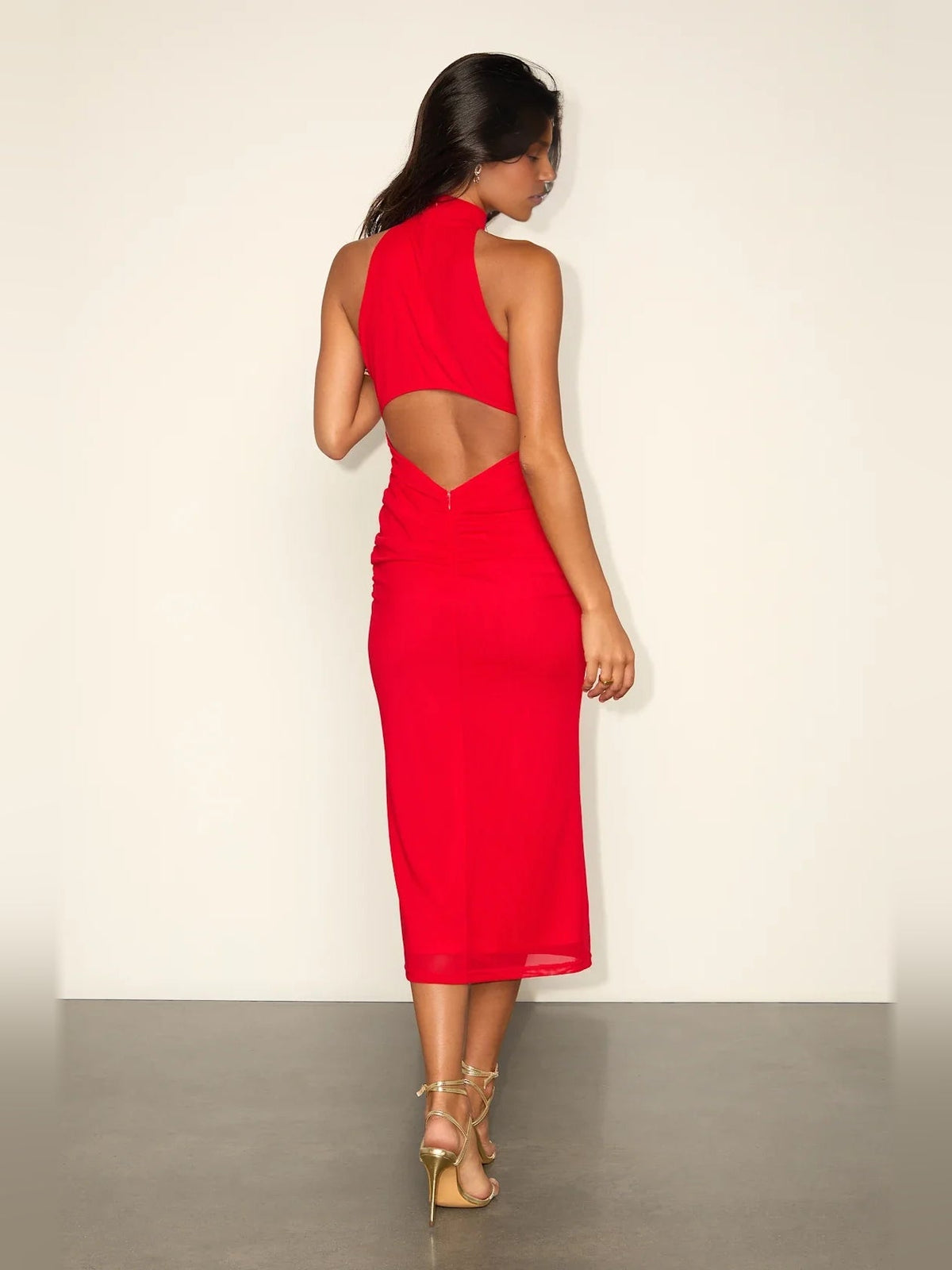Dark red ruched halter cut-out sheath mini dress with open back detail.