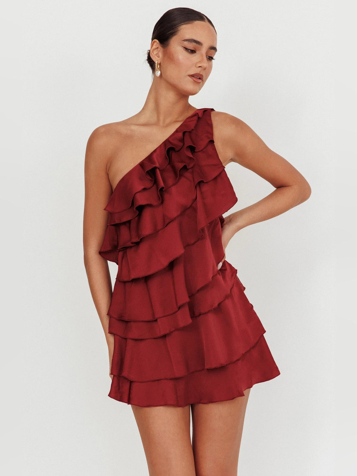 Wine tiered ruffled one-shoulder mini dress with cascading ruffle tiers at front