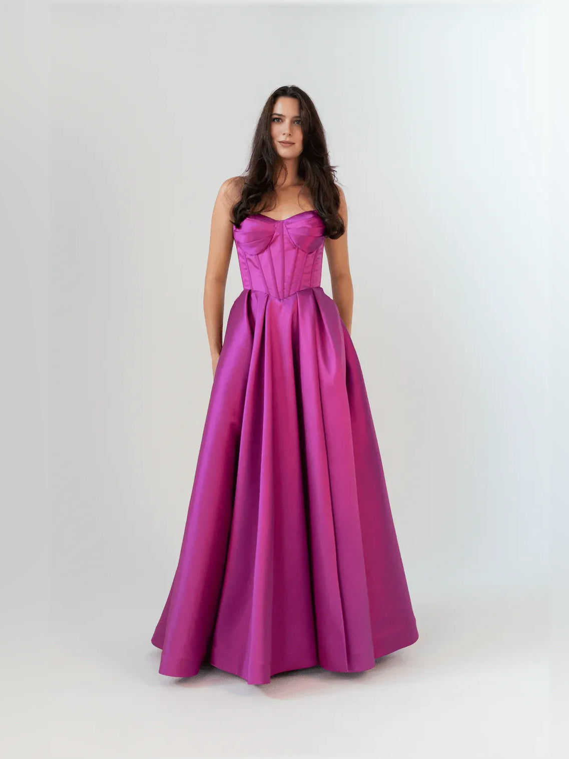 Magenta strapless corset-style formal dress with sweetheart neckline, floor-length skirt