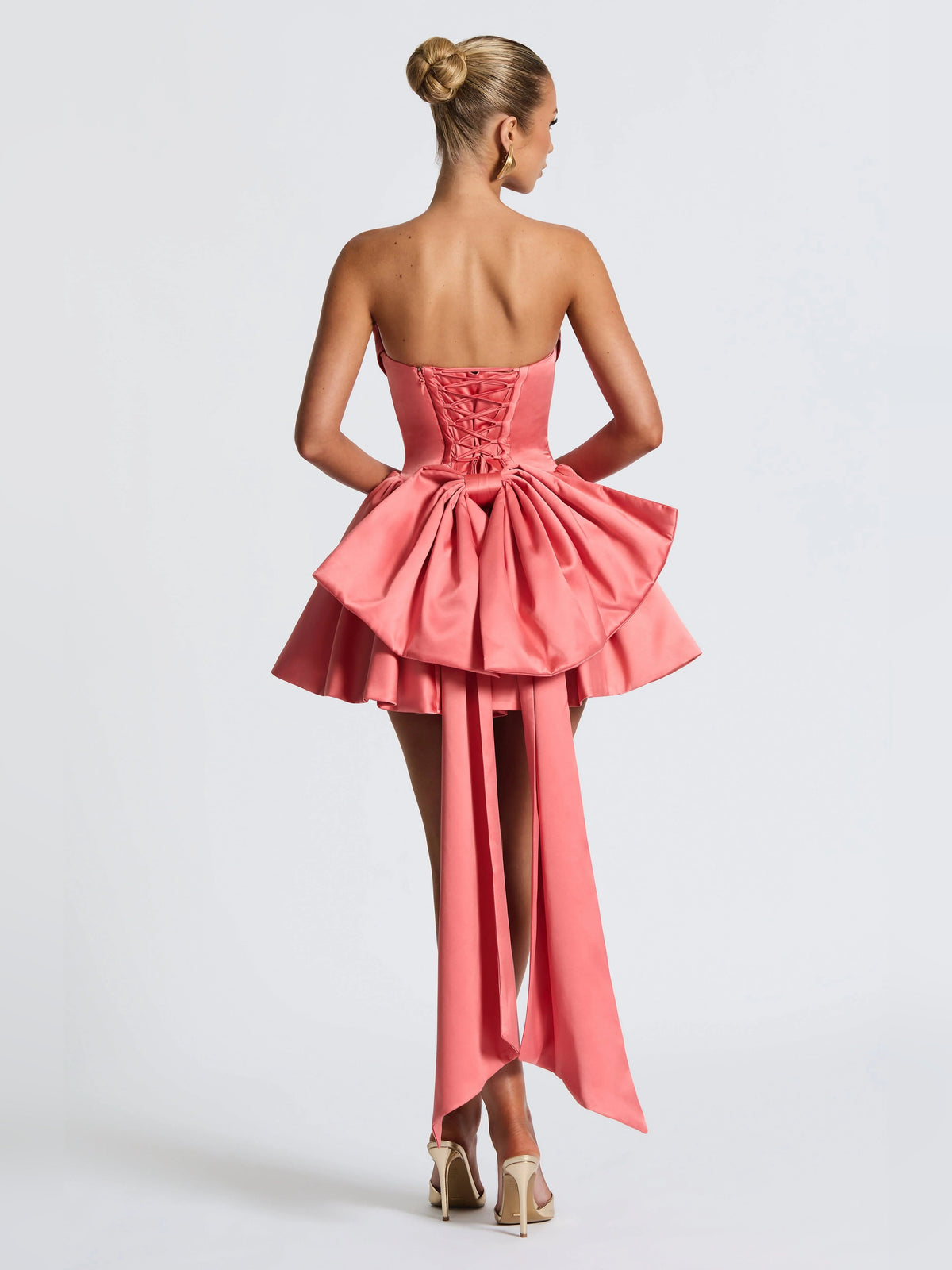 Pink backless mini dress with corset lacing and flowing asymmetrical back drape