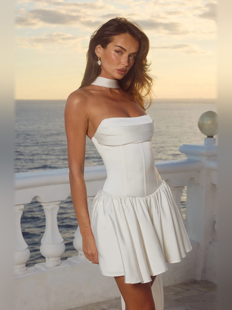 Ivory strapless mini dress with high halter neckline and gathered tiered flared skirt