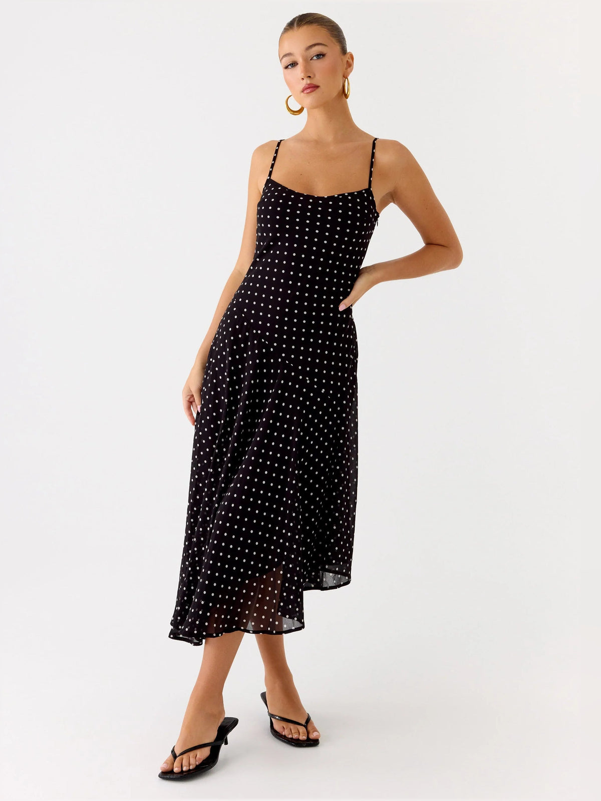 Black midi formal dress 3/4 view: thin straps, square neckline, allover dotted sparkle, asym hem