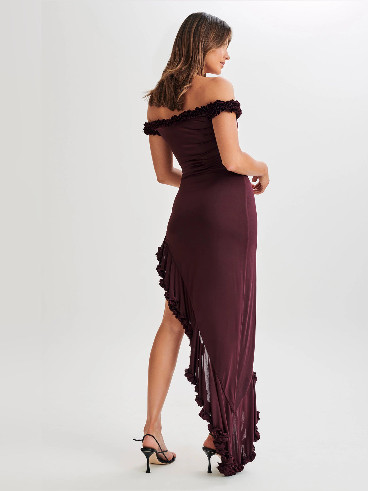 Plum off-shoulder ruffle midi dress shown from back angle with side slit
